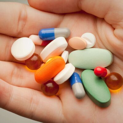 Prescription drugs in hand close-up