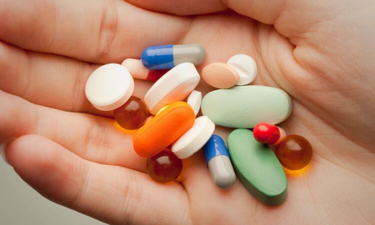 Prescription drugs in hand close-up