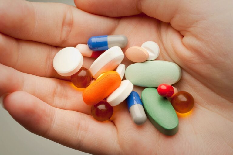 Prescription drugs in hand close-up